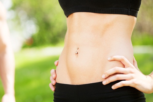 Sexy and fit belly on young woman